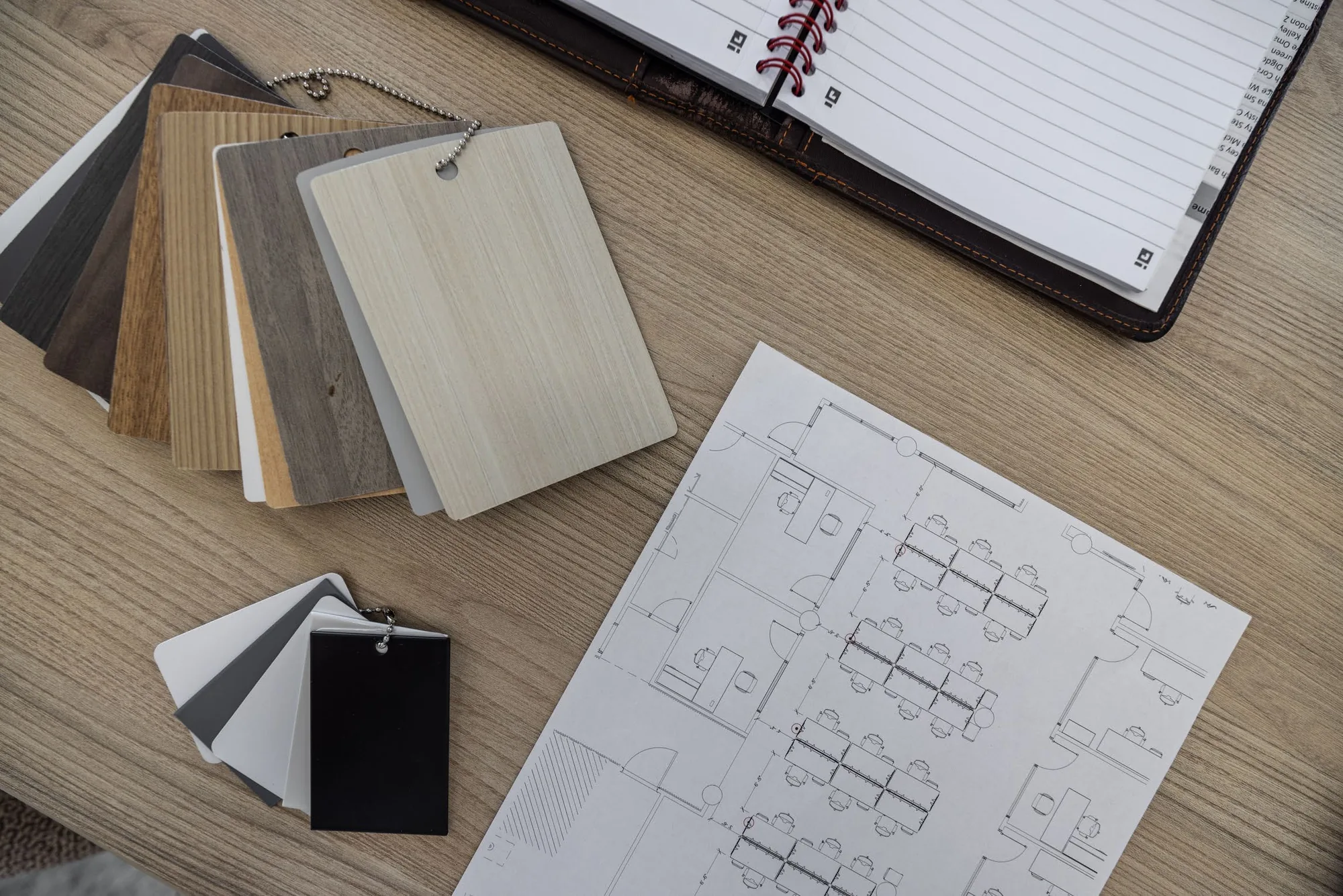 Finish samples and a printed floor plan on a desk